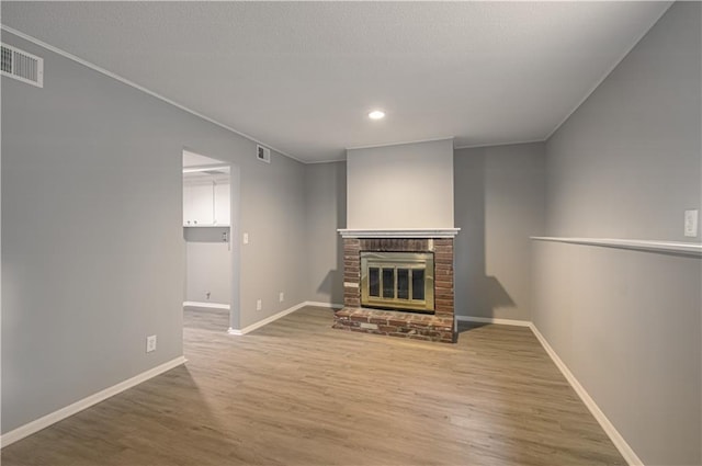 9406 Switzer St, Overland Park, KS 66214 - unfurnished living room with wood finished floors, baseboards, a fireplace, and recessed lighting