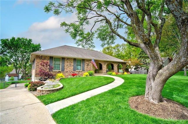 1014 SW Twilight Ln, Blue Springs, MO 64015 - view of front facade featuring brick siding and a shingled roof