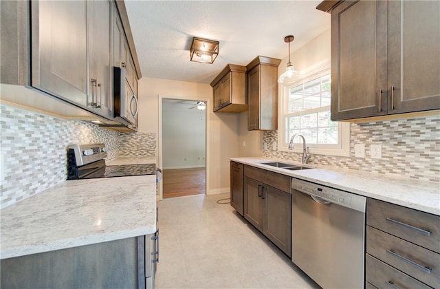 1014 SW Twilight Ln, Blue Springs, MO 64015 - kitchen with stainless steel appliances, a ceiling fan, backsplash, and light stone countertops