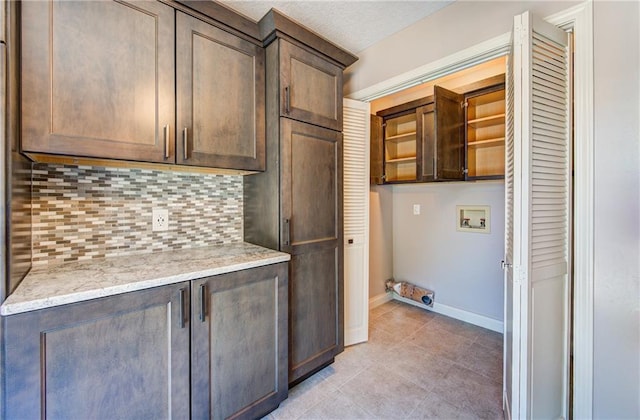 1014 SW Twilight Ln, Blue Springs, MO 64015 - laundry room with cabinet space, washer hookup, hookup for an electric dryer, and light tile patterned floors
