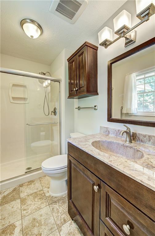 1014 SW Twilight Ln, Blue Springs, MO 64015 - bathroom with vanity and a shower stall