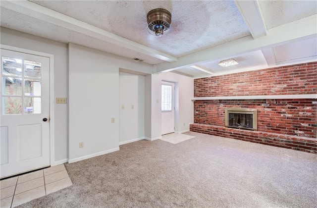 1014 SW Twilight Ln, Blue Springs, MO 64015 - unfurnished living room featuring carpet floors, a textured ceiling, a brick fireplace, and beam ceiling