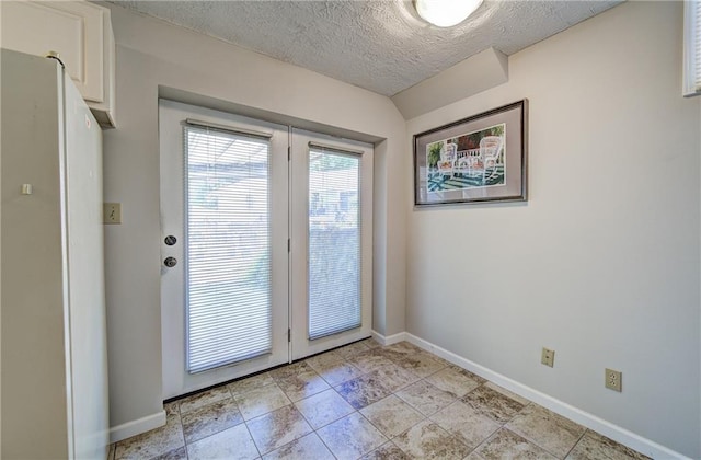 1014 SW Twilight Ln, Blue Springs, MO 64015 - doorway to outside featuring baseboards and a textured ceiling