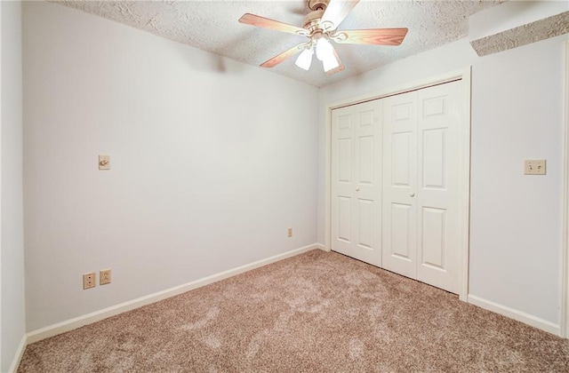 1014 SW Twilight Ln, Blue Springs, MO 64015 - unfurnished bedroom featuring carpet, a textured ceiling, a closet, and a ceiling fan