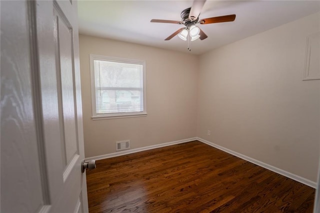 10203 Fremont Ave, Kansas City, MO 64134 - empty room with dark wood-style flooring, ceiling fan, and baseboards
