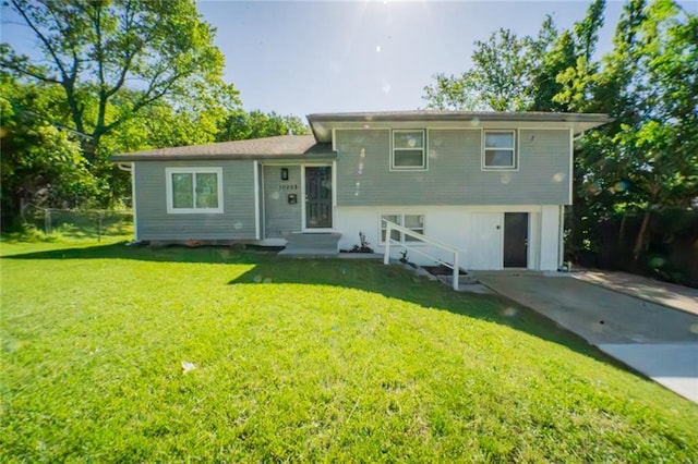 10203 Fremont Ave, Kansas City, MO 64134 - rear view of house featuring a lawn