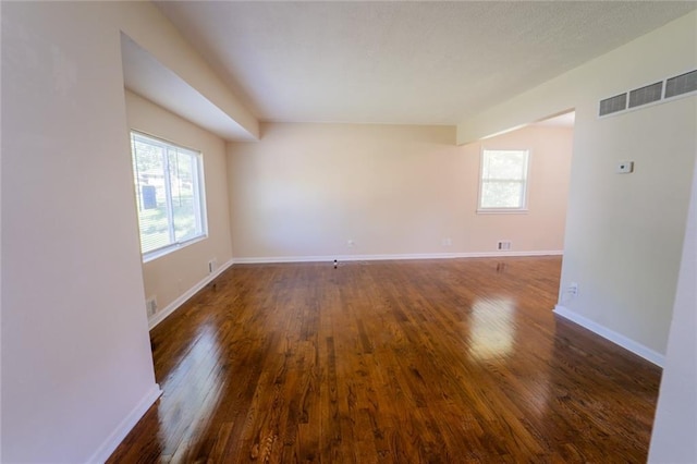 10203 Fremont Ave, Kansas City, MO 64134 - empty room with plenty of natural light, wood finished floors, and baseboards
