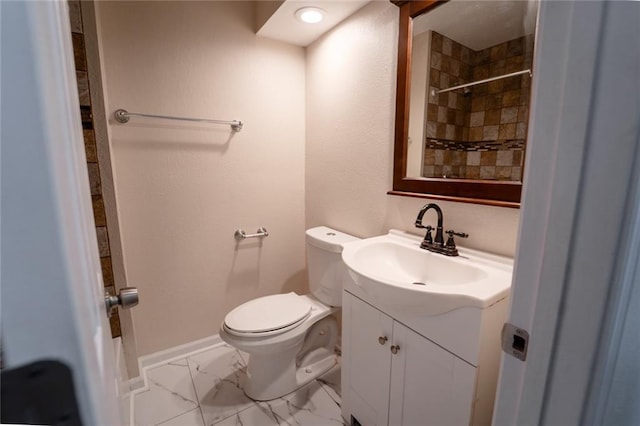 10203 Fremont Ave, Kansas City, MO 64134 - full bath featuring vanity, toilet, tiled shower, marble look tile flooring, and baseboards