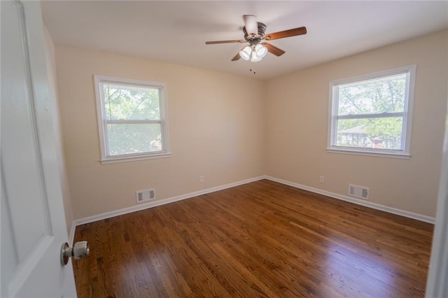 10203 Fremont Ave, Kansas City, MO 64134 - spare room with plenty of natural light, dark wood finished floors, baseboards, and a ceiling fan