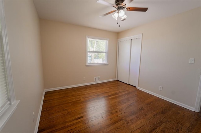 10203 Fremont Ave, Kansas City, MO 64134 - unfurnished bedroom featuring baseboards, wood finished floors, and a ceiling fan