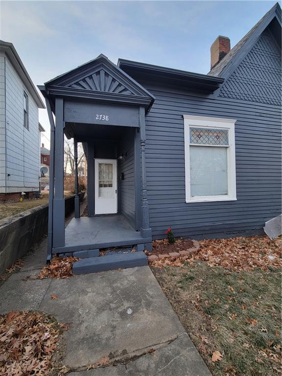 doorway to property featuring a chimney