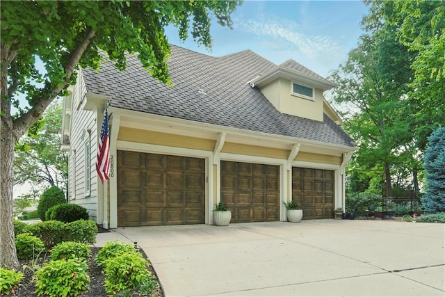 20800 W 94th Ter, Lenexa, KS 66220 - view of front of property featuring driveway, a shingled roof, and an attached garage