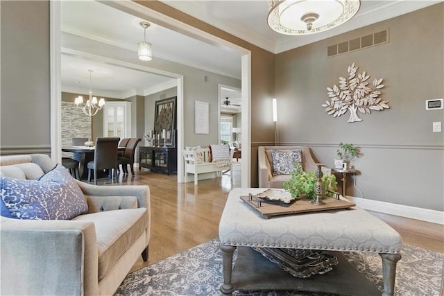 20800 W 94th Ter, Lenexa, KS 66220 - living area with a chandelier, plenty of natural light, wood finished floors, crown molding, and baseboards