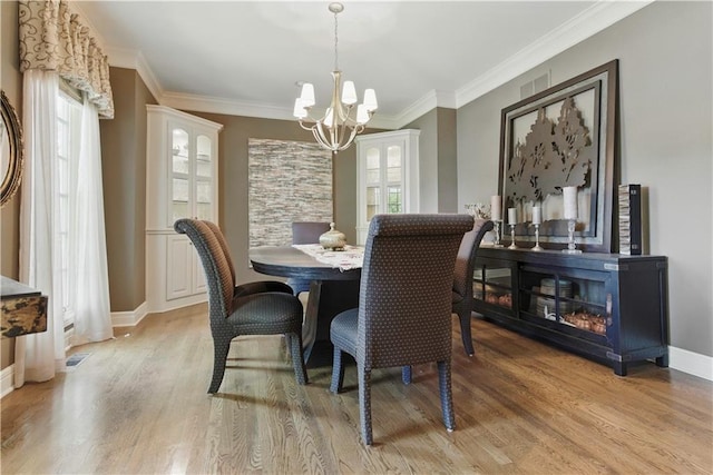 20800 W 94th Ter, Lenexa, KS 66220 - dining room with a chandelier, healthy amount of natural light, light wood-type flooring, baseboards, and ornamental molding