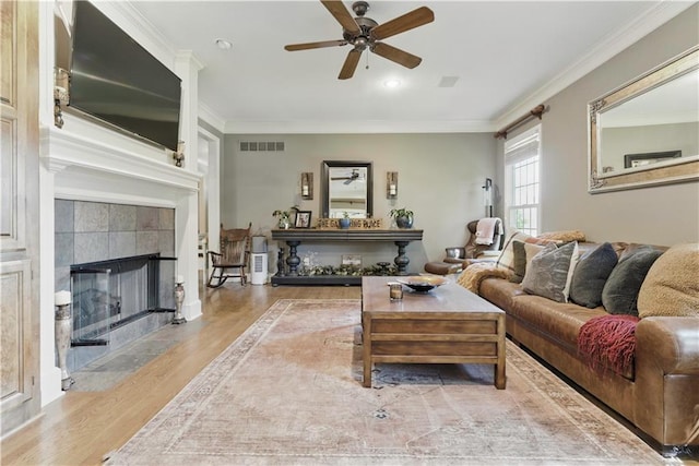 20800 W 94th Ter, Lenexa, KS 66220 - living area featuring a ceiling fan, wood finished floors, a fireplace, crown molding, and recessed lighting