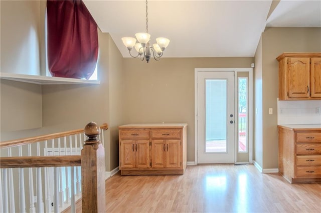 1703 Rolling Rock Rd, Raymore, MO 64083 - dining room with light wood finished floors and a chandelier