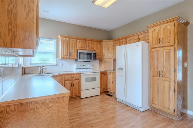 1703 Rolling Rock Rd, Raymore, MO 64083 - kitchen featuring white appliances, light wood-style flooring, backsplash, and light countertops