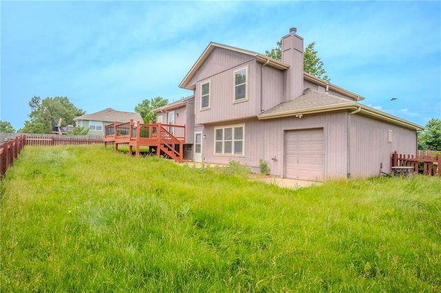 1703 Rolling Rock Rd, Raymore, MO 64083 - back of property featuring a chimney, a wooden deck, and an attached garage