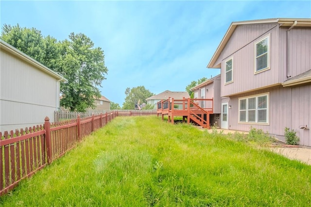 1703 Rolling Rock Rd, Raymore, MO 64083 - fenced backyard with a wooden deck and stairs