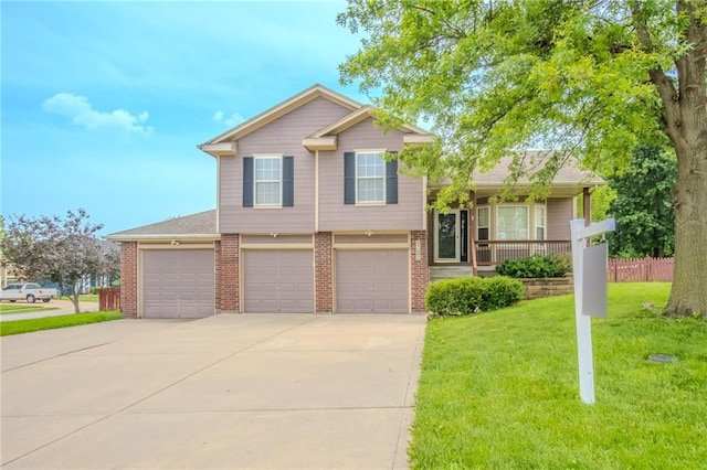 1703 Rolling Rock Rd, Raymore, MO 64083 - tri-level home featuring driveway, a garage, a front yard, and brick siding