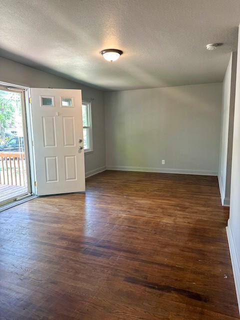 307 SW Glendana St, Lees Summit, MO 64081 - foyer featuring a textured ceiling, baseboards, healthy amount of natural light, and dark wood finished floors