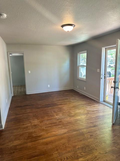 307 SW Glendana St, Lees Summit, MO 64081 - spare room with a textured ceiling, dark wood finished floors, a smoke detector, and baseboards