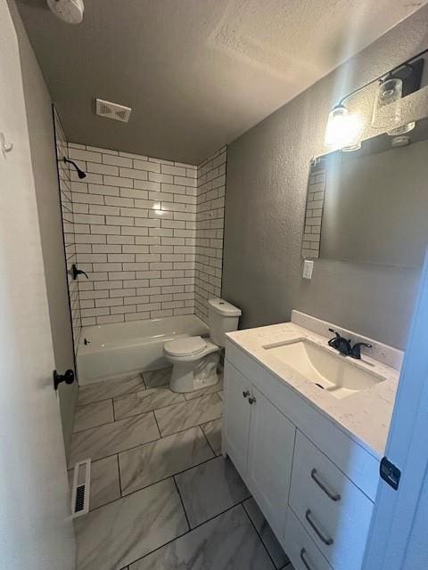 307 SW Glendana St, Lees Summit, MO 64081 - full bathroom featuring a textured wall, marble finish flooring, a textured ceiling, toilet, and vanity