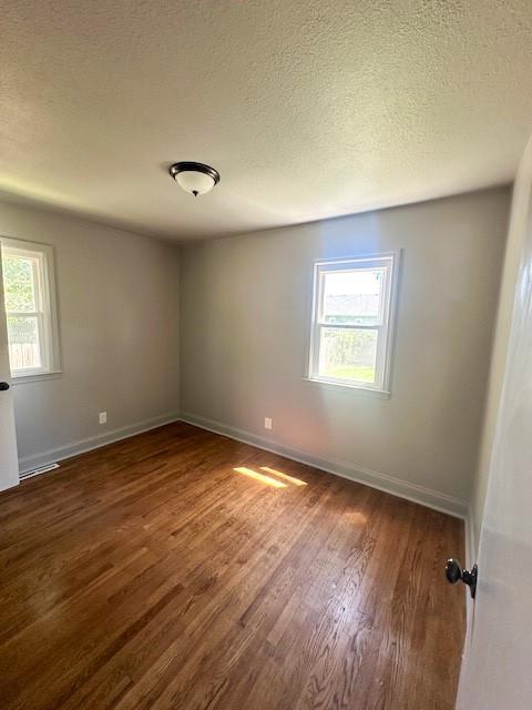 307 SW Glendana St, Lees Summit, MO 64081 - unfurnished room featuring wood finished floors, baseboards, and a textured ceiling