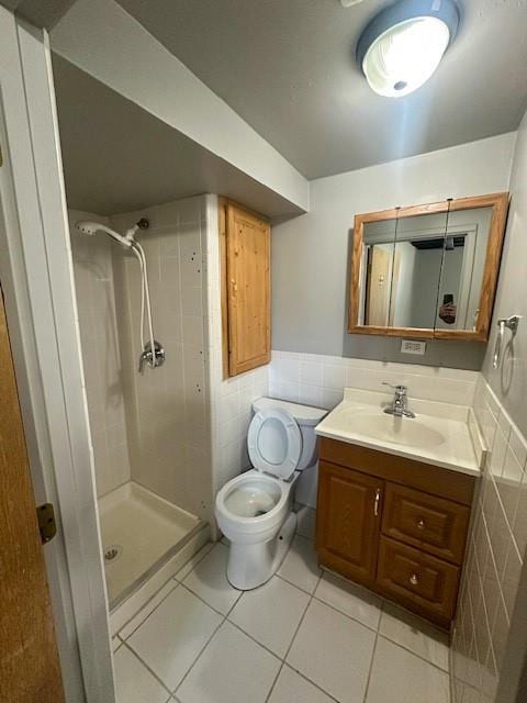 307 SW Glendana St, Lees Summit, MO 64081 - full bathroom featuring tile walls, a stall shower, tile patterned flooring, vanity, and toilet