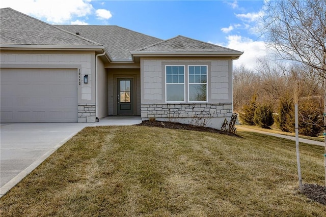 view of front facade featuring a shingled roof, stone siding, driveway, a garage, and a front lawn