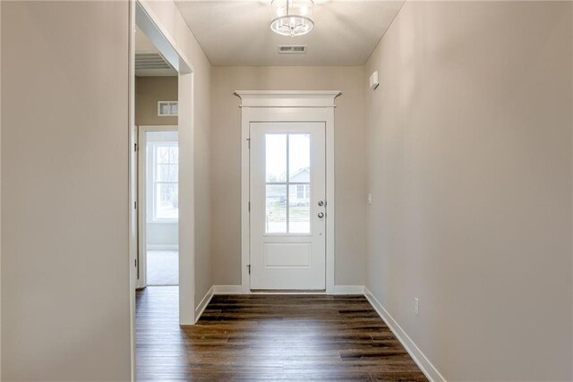 entryway with dark wood-style floors and baseboards