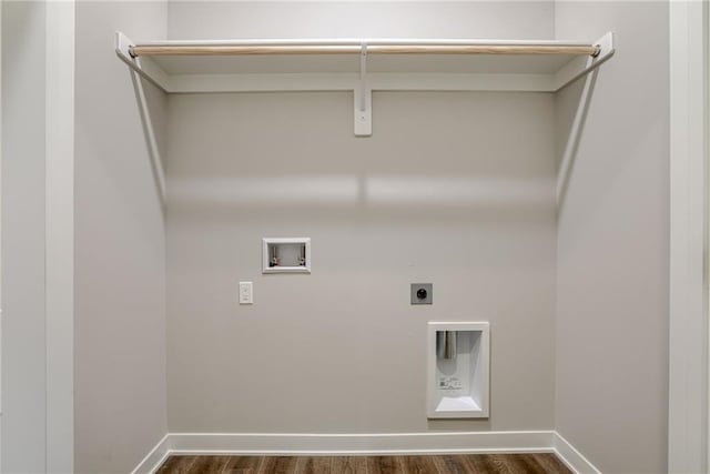 washroom with hookup for an electric dryer, washer hookup, dark wood-style flooring, and baseboards