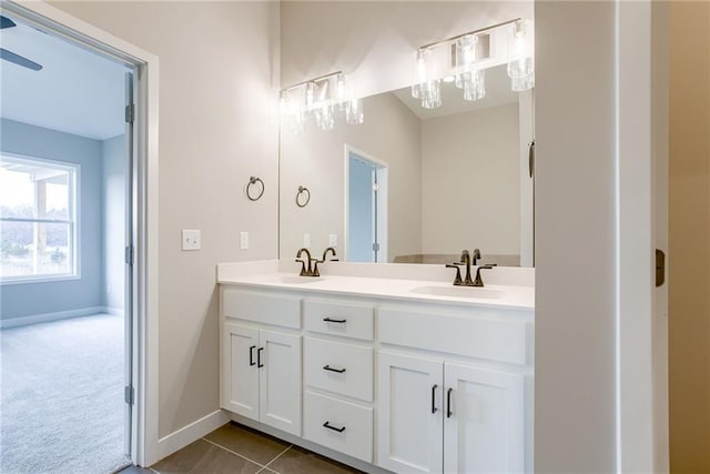 bathroom featuring double vanity, baseboards, and tile patterned floors