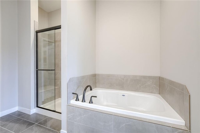 bathroom featuring a shower stall, tile patterned floors, and a garden tub