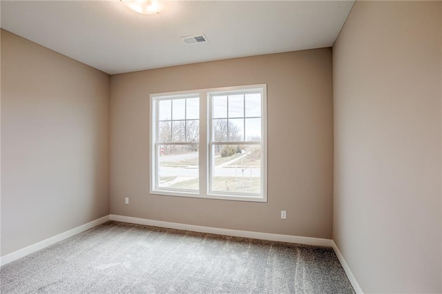 carpeted spare room with baseboards