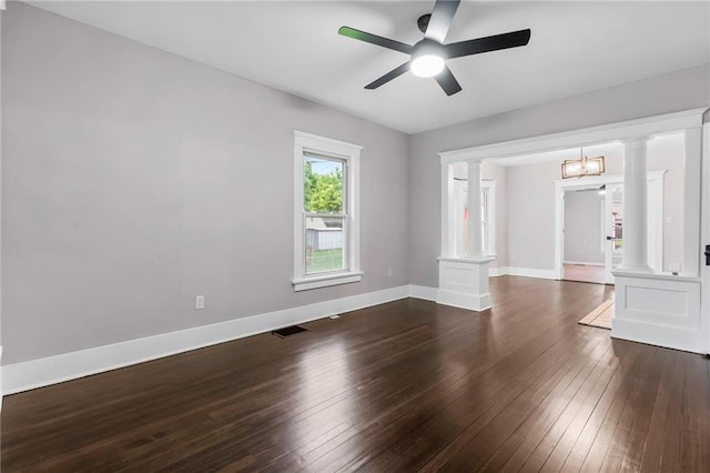312 2nd St, Ferrelview, MO 64163 - spare room featuring ornate columns, dark wood-type flooring, a ceiling fan, and baseboards