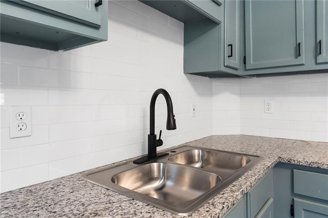 312 2nd St, Ferrelview, MO 64163 - kitchen with a sink, backsplash, and blue cabinets