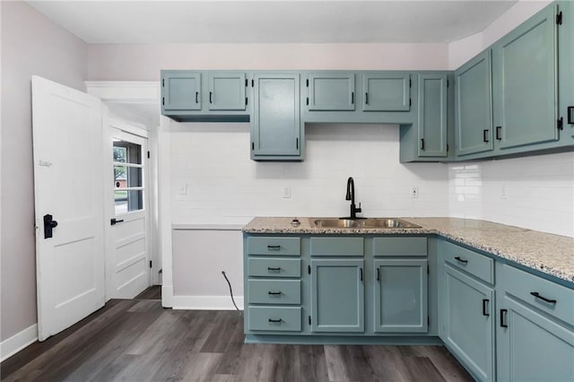 312 2nd St, Ferrelview, MO 64163 - kitchen with a sink, dark wood-style flooring, and baseboards