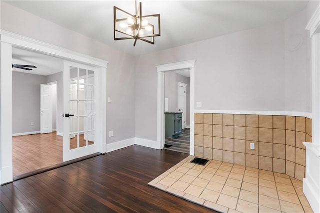 312 2nd St, Ferrelview, MO 64163 - unfurnished dining area with wood finished floors, a chandelier, and baseboards
