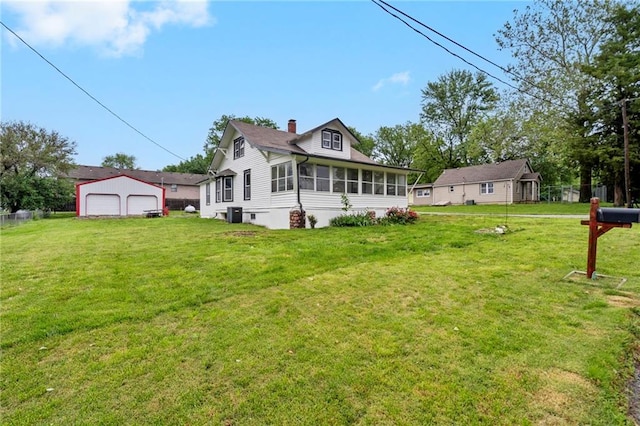 312 2nd St, Ferrelview, MO 64163 - back of house featuring a sunroom, a chimney, a detached garage, and a yard