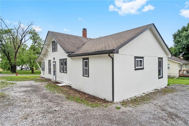 312 2nd St, Ferrelview, MO 64163 - view of property exterior featuring a chimney and roof with shingles