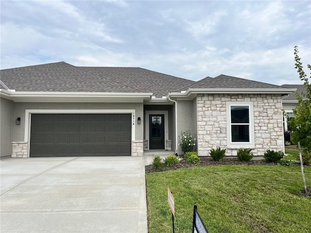 view of front of property with stone siding, an attached garage, a front yard, concrete driveway, and a shingled roof