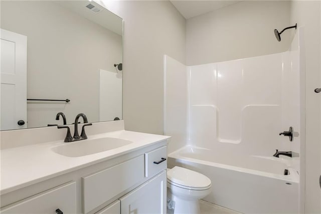 bathroom featuring toilet, vanity, and shower / bathtub combination