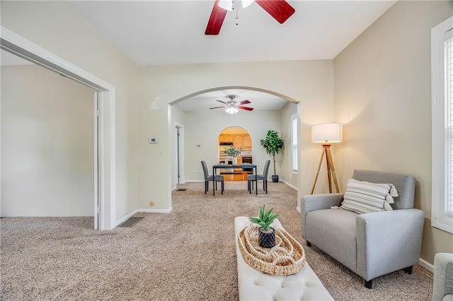1503 S Spring St, Independence, MO 64055 - living area with a ceiling fan, arched walkways, and carpet
