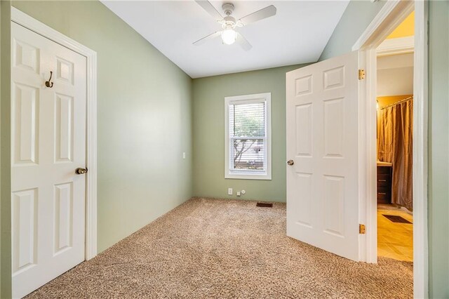 1503 S Spring St, Independence, MO 64055 - unfurnished bedroom featuring carpet floors, vaulted ceiling, and a ceiling fan