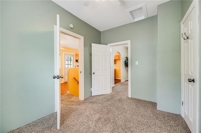 1503 S Spring St, Independence, MO 64055 - hallway with carpet, attic access, and arched walkways
