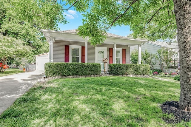 1503 S Spring St, Independence, MO 64055 - view of front of property featuring covered porch, a front lawn, and a garage