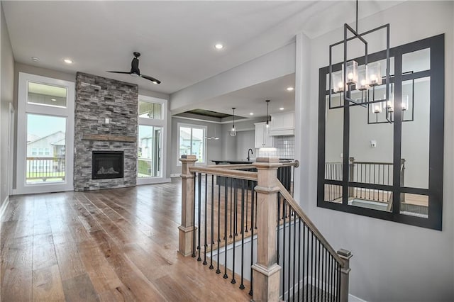 24105 W 58th Pl, Shawnee, KS 66226 - corridor with an upstairs landing, hardwood / wood-style floors, a chandelier, a sink, and baseboards