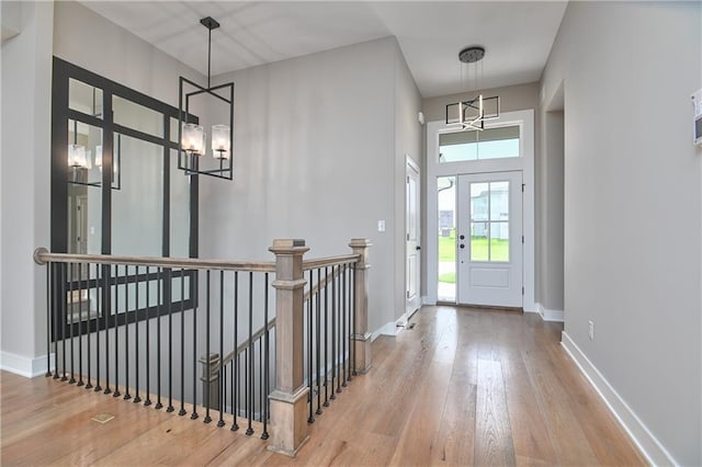 24105 W 58th Pl, Shawnee, KS 66226 - entrance foyer featuring a chandelier, hardwood / wood-style floors, baseboards, and a high ceiling