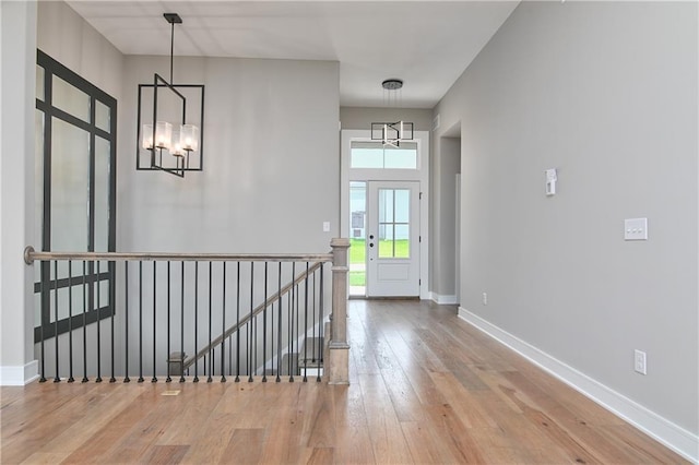 24105 W 58th Pl, Shawnee, KS 66226 - foyer featuring a chandelier, hardwood / wood-style flooring, and baseboards